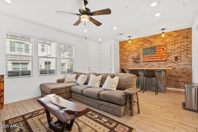 living area with baseboards, a ceiling fan, light wood-style flooring, and recessed lighting