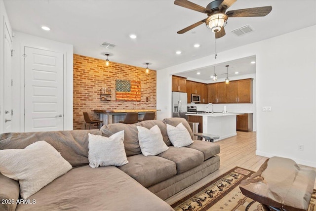 living area with visible vents, recessed lighting, light wood-style flooring, and ceiling fan