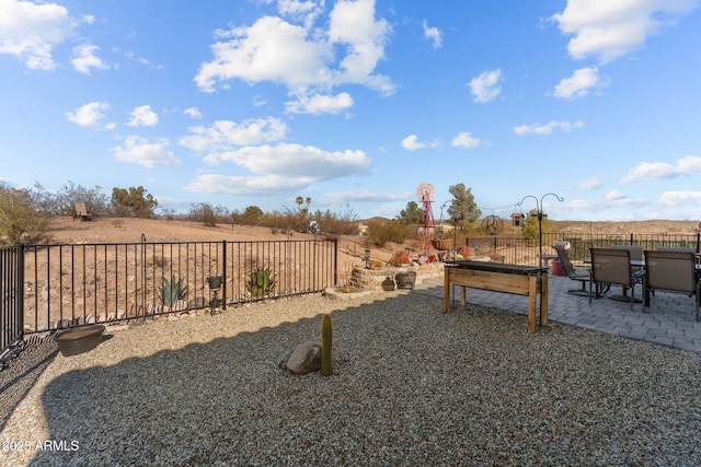 view of yard featuring a rural view and a patio area