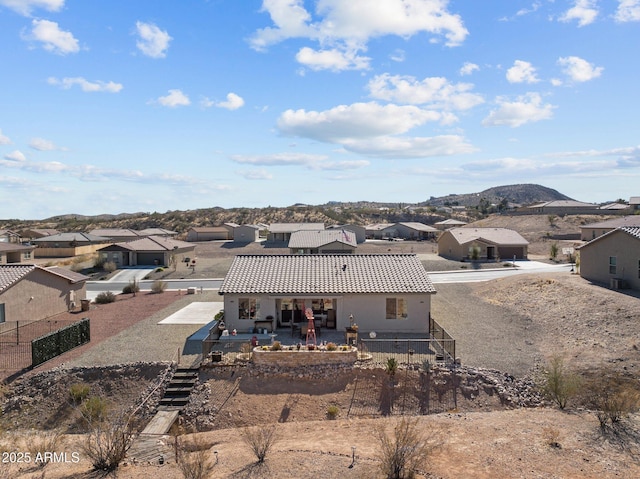 rear view of house with a patio area and a mountain view