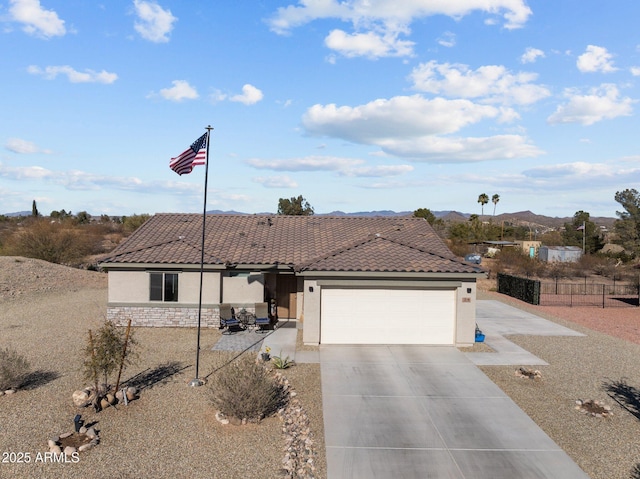 view of front facade featuring a garage and a mountain view