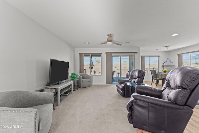 living room with ceiling fan and light carpet