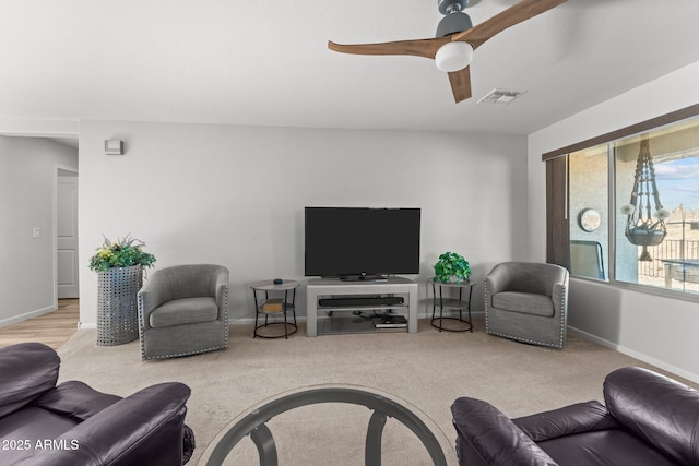 living room featuring ceiling fan and light colored carpet