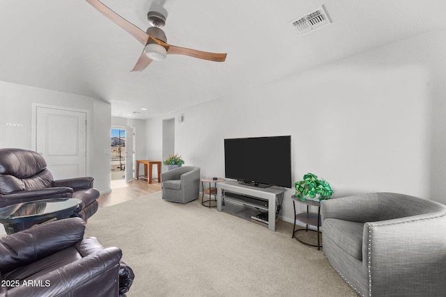 carpeted living room featuring ceiling fan