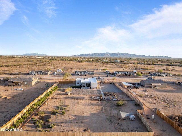 drone / aerial view featuring a mountain view and view of desert