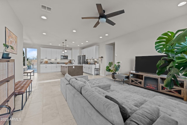 living room featuring visible vents, a ceiling fan, recessed lighting, and light tile patterned floors