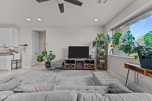 living room with ceiling fan, baseboards, visible vents, and recessed lighting