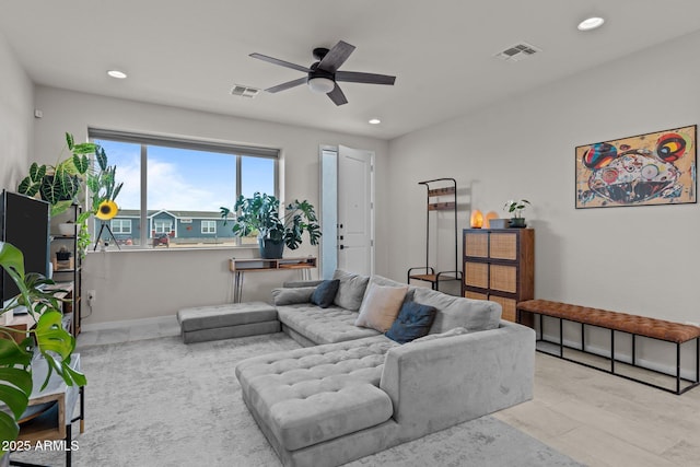 living area featuring ceiling fan, visible vents, and recessed lighting