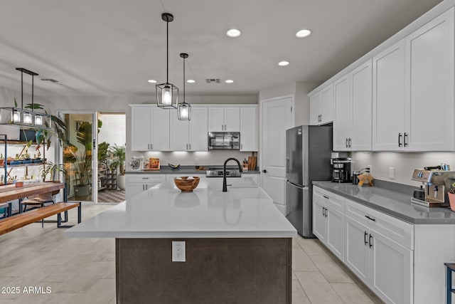 kitchen featuring white cabinetry, pendant lighting, recessed lighting, and stainless steel appliances
