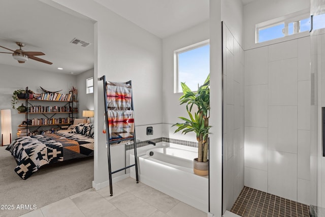 full bath with visible vents, ceiling fan, a garden tub, and a healthy amount of sunlight