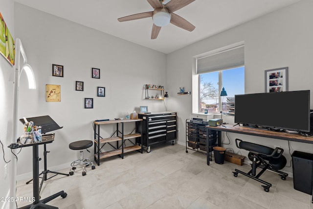 office space with baseboards and a ceiling fan