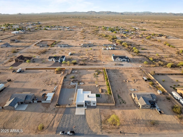 drone / aerial view featuring a mountain view and view of desert