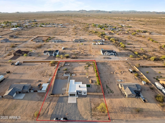 birds eye view of property featuring a mountain view and a desert view