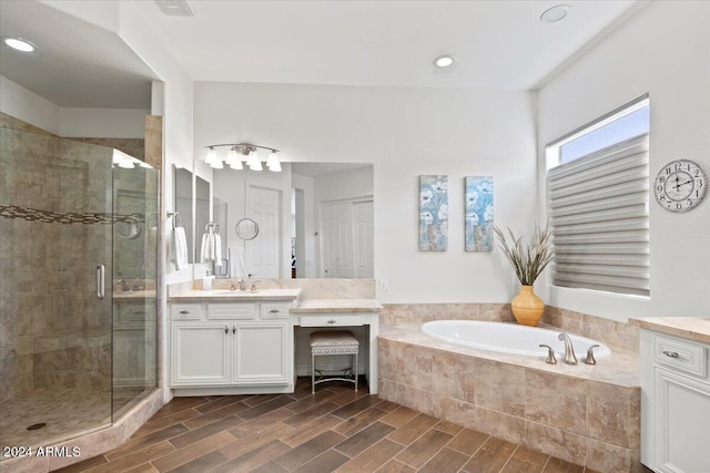 bathroom featuring vanity and shower with separate bathtub