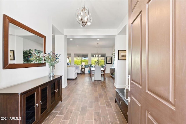 foyer entrance with a chandelier and light wood-type flooring