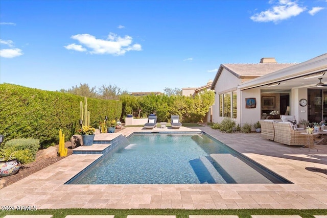 view of pool featuring an outdoor hangout area, pool water feature, and a patio area