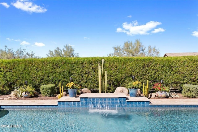 view of pool with pool water feature