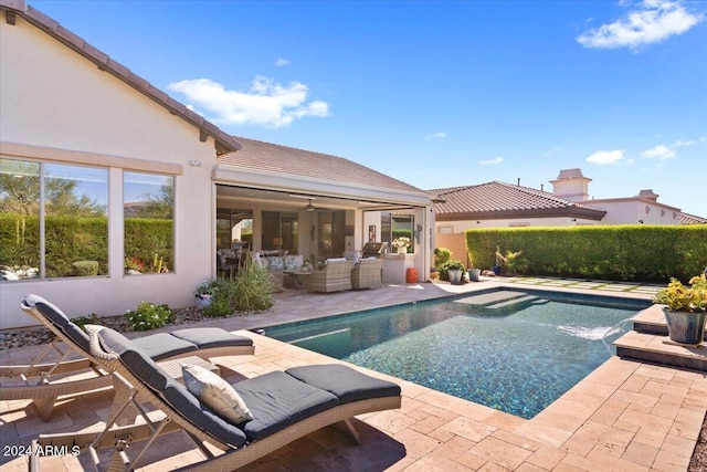 view of pool with a patio area, an outdoor living space, and pool water feature