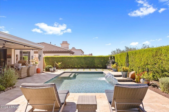 view of pool with pool water feature, an outdoor hangout area, and a patio area