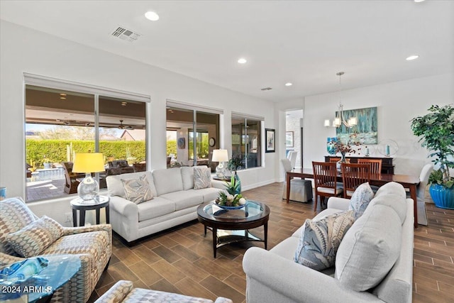 living room with a healthy amount of sunlight and an inviting chandelier