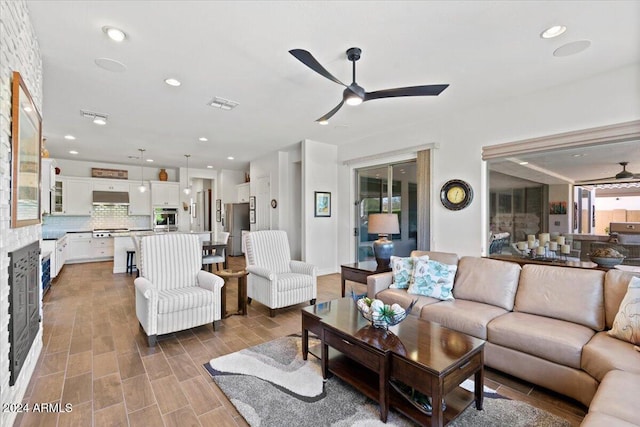 living room with hardwood / wood-style flooring and ceiling fan