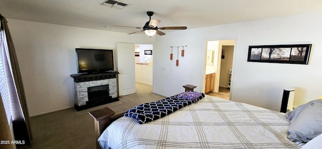 bedroom with visible vents, connected bathroom, a fireplace, carpet flooring, and baseboards