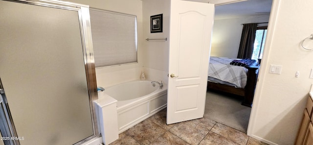 ensuite bathroom featuring a garden tub, ensuite bath, and a stall shower