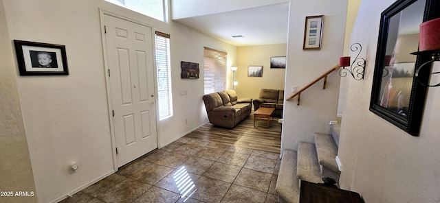 tiled entrance foyer with stairway and visible vents