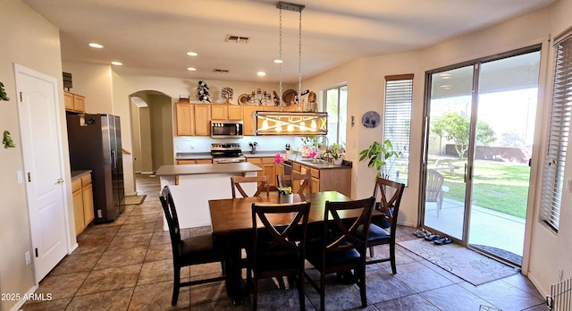 dining space featuring recessed lighting, arched walkways, and visible vents