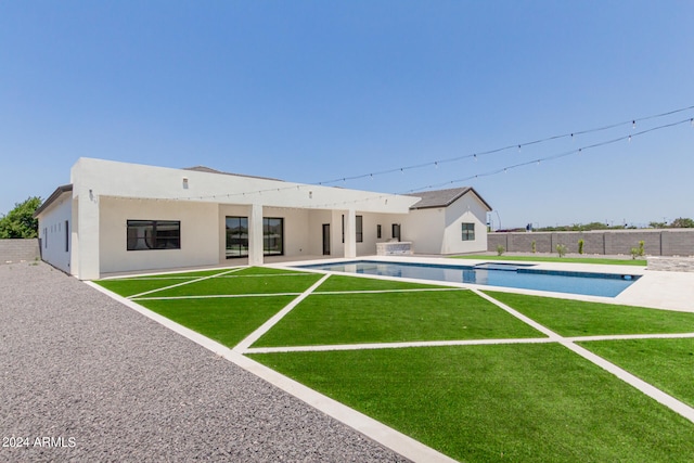 exterior space featuring a lawn, a patio, and a fenced in pool