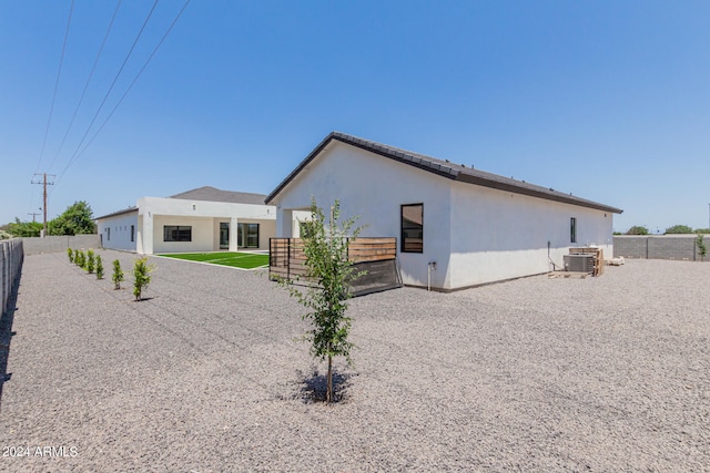 rear view of house featuring cooling unit