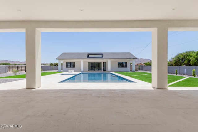 view of swimming pool with a patio and a yard