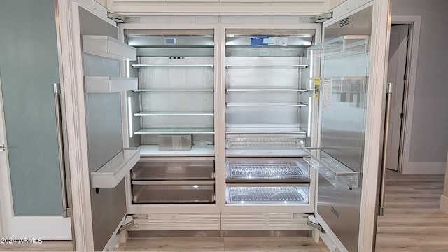 details featuring fridge and light hardwood / wood-style flooring