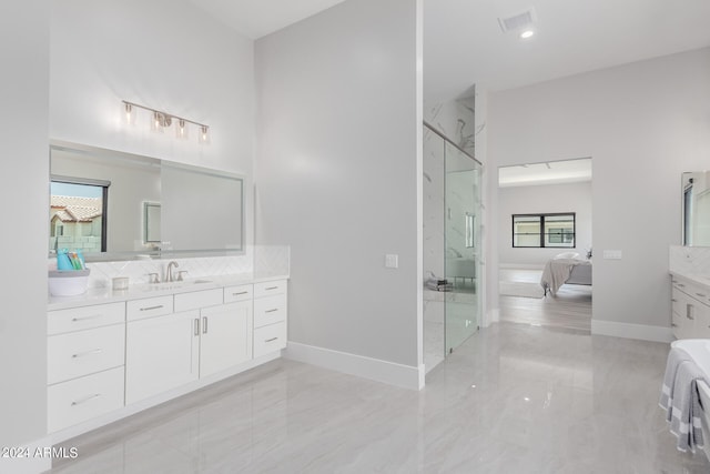 bathroom featuring walk in shower, vanity, and plenty of natural light