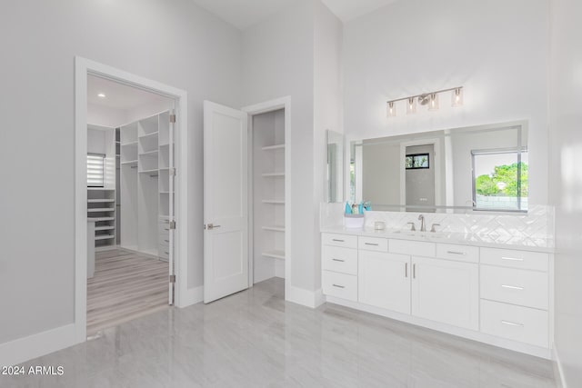 bathroom featuring vanity and a towering ceiling