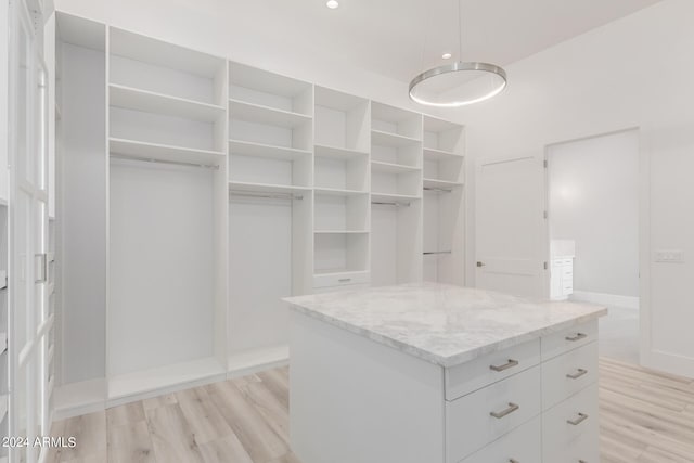 walk in closet featuring light hardwood / wood-style flooring