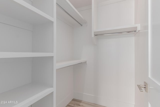 walk in closet featuring light hardwood / wood-style flooring