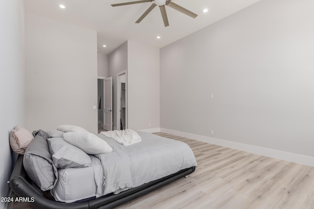 bedroom with light hardwood / wood-style floors and ceiling fan