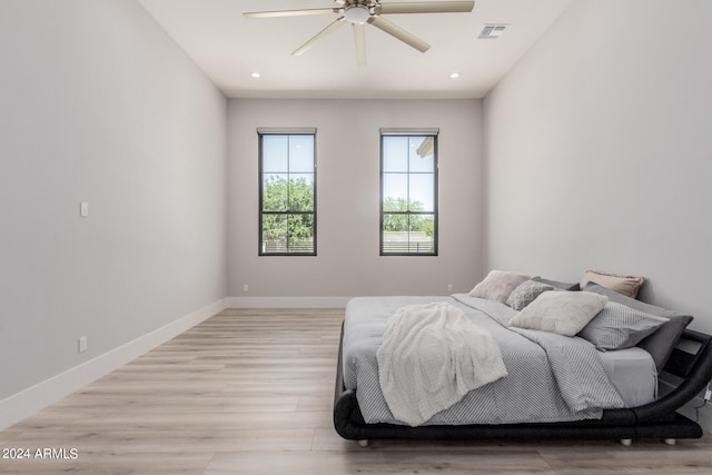 bedroom with ceiling fan and light hardwood / wood-style flooring