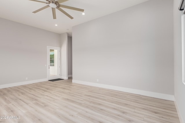 empty room featuring ceiling fan and light hardwood / wood-style flooring