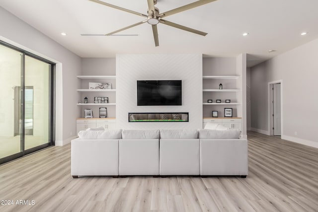 living room featuring light hardwood / wood-style floors, ceiling fan, and built in features