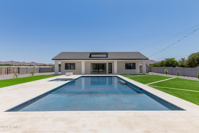 view of pool featuring a lawn and a patio