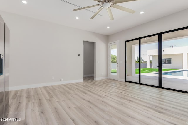 spare room featuring light hardwood / wood-style floors and ceiling fan