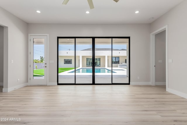 spare room with light hardwood / wood-style flooring and ceiling fan