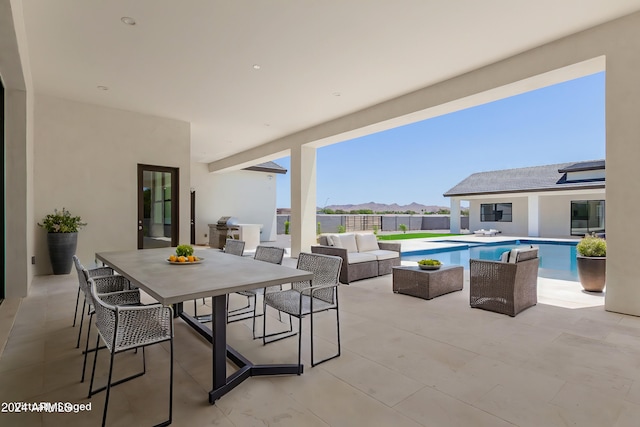 view of patio with an outdoor hangout area and a fenced in pool