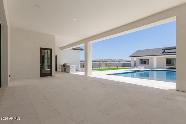 view of swimming pool featuring area for grilling and a patio area