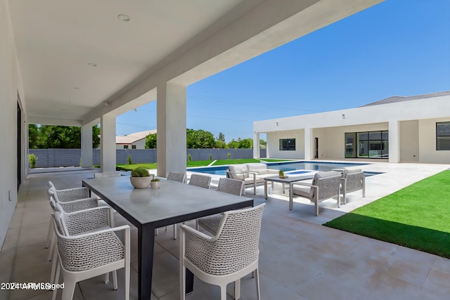 view of patio with a fenced in pool and an outdoor living space