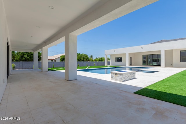 view of pool with a patio and a hot tub