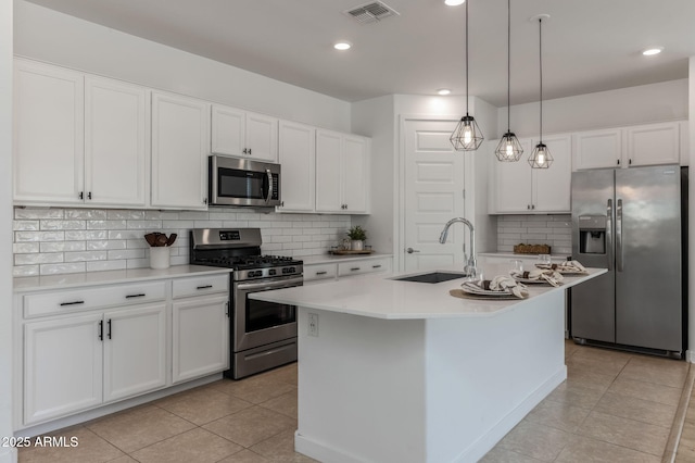 kitchen with a sink, stainless steel appliances, visible vents, and light tile patterned flooring