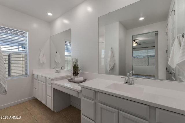 bathroom featuring tile patterned floors, recessed lighting, double vanity, and a sink